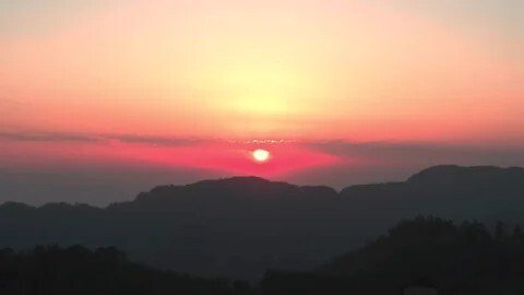 Best time to see sunset in Dehradun — panoramic view of Doon Valley glowing at golden hour from Mussoorie ridge